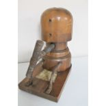 An antique wooden hat stretcher