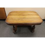 A continental oak coffee table on bun feet