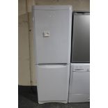 An Indesit frost free upright fridge freezer