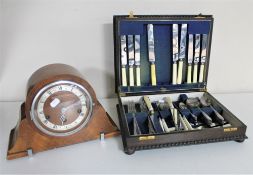 An oak canteen of cutlery and a mantel clock