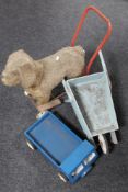 A mid 20th century push along soft toy dog on trolley,
