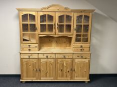 A stripped pine four door kitchen dresser