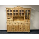 A stripped pine four door kitchen dresser