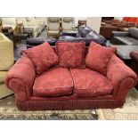 A two seater Victorian style settee in red brocade