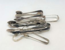 Eleven pairs of silver sugar tongs,