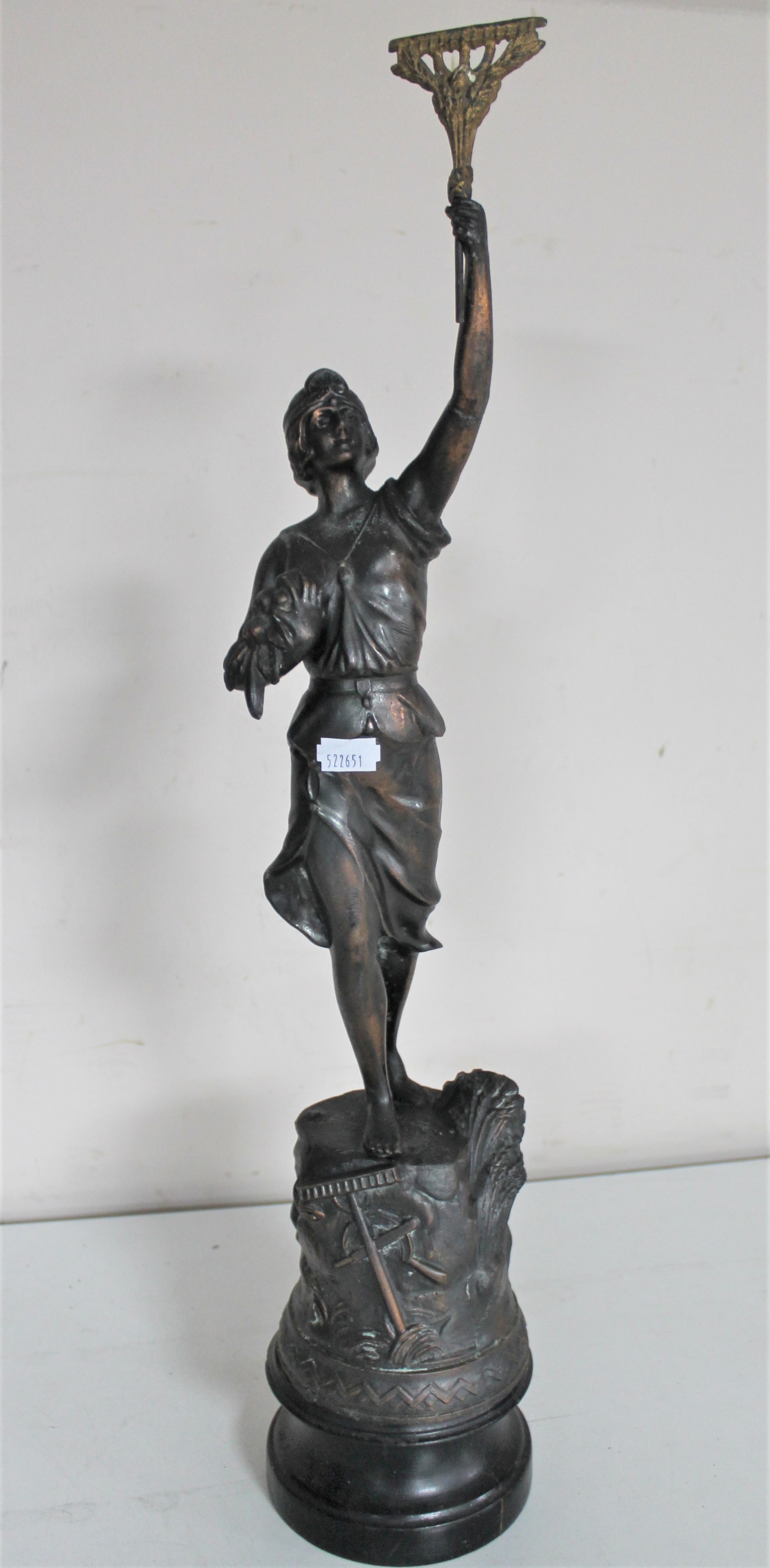 An antique spelter figure of a female with arm raised