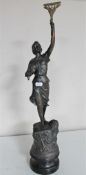 An antique spelter figure of a female with arm raised