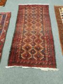 An Afghan rug on red ground,