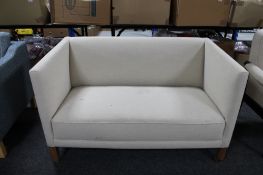 A 20th century Danish two seater settee in oatmeal fabric