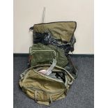 A fishing bag containing assorted accessories, reels, landing nets,