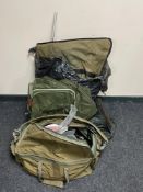 A fishing bag containing assorted accessories, reels, landing nets,