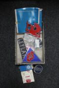 A box of 20th century car badges - AEG, Leyland, BMW,