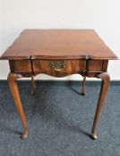 A shaped antique mahogany occasional table