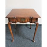 A shaped antique mahogany occasional table