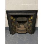 An antique cast iron tiled fire place