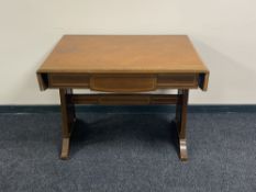 An antique inlaid mahogany flap sided sofa table