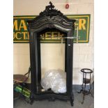 A black French style armoire, lacking back,
