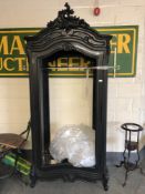 A black French style armoire, lacking back,