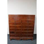 A 20th century continental mahogany fourteen drawer chest