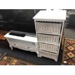 A painted white four drawer chest with wicker drawers and a TV stand