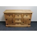 A Mexican pine sideboard fitted five drawers