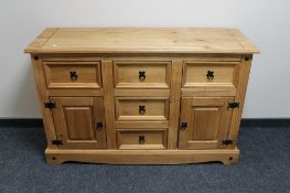 A Mexican pine sideboard fitted five drawers