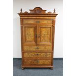 An antique mahogany and walnut double door cocktail cabinet