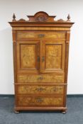 An antique mahogany and walnut double door cocktail cabinet