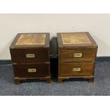 A pair of two drawer campaign style bedside chests with brass mounts