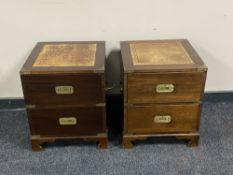 A pair of two drawer campaign style bedside chests with brass mounts