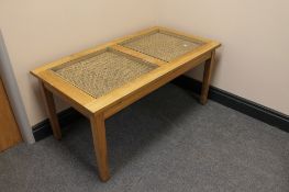 A teak and rattan coffee table