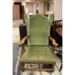 A 20th century oak wingback armchair in green dralon