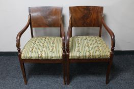 A pair of continental mahogany Regency style armchairs in striped fabric