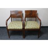 A pair of continental mahogany Regency style armchairs in striped fabric