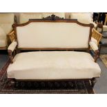 An antique mahogany framed settee in cream fabric