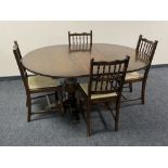 A circular pedestal Jaycee Oak extending dining table and four chairs