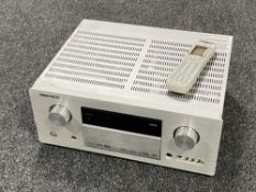 A Marantz SR7001 AV surround receiver with two remotes (continental wiring)