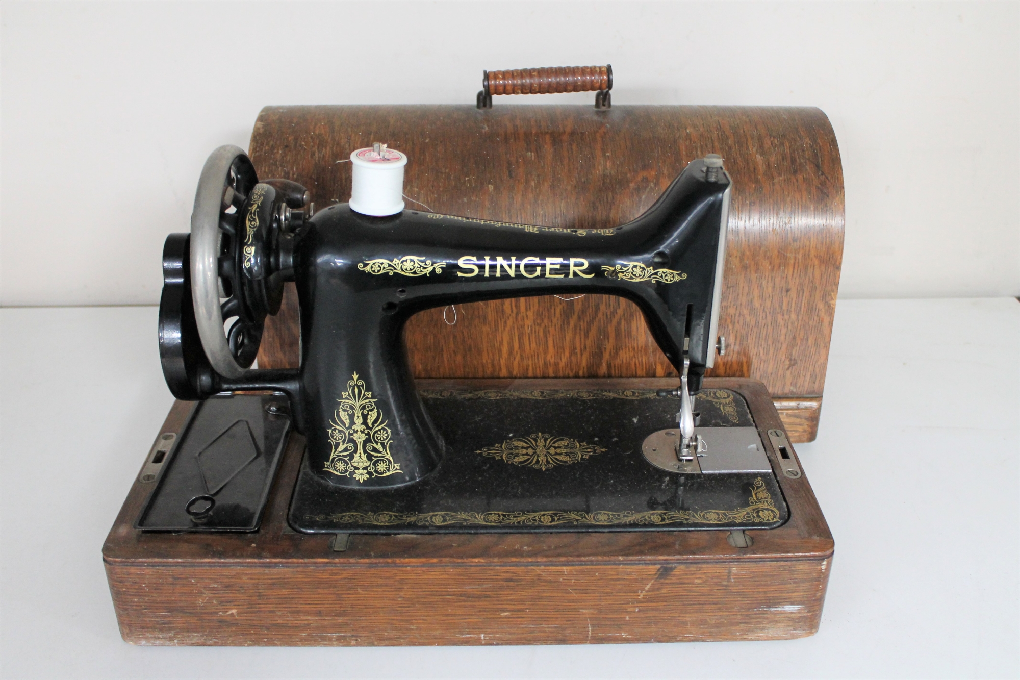 A vintage oak cased Singer hand sewing machine