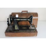 A vintage oak cased Singer hand sewing machine