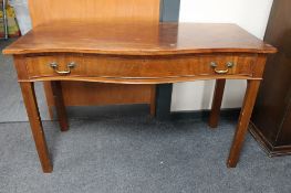 An early 20th century serpentine fronted hall table