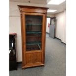 A continental walnut glazed bookcase, width 82 cm.