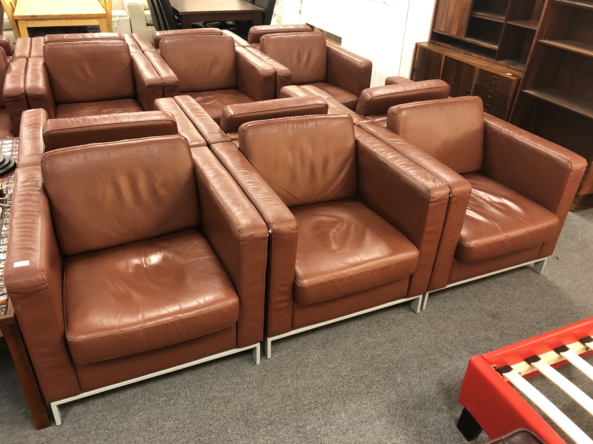 Three contemporary brown leather look armchairs