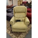 An electric reclining armchair in sand coloured fabric