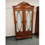 A Continental mahogany double door cabinet,