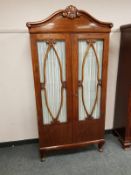 A Continental mahogany double door cabinet,