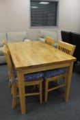 A pine kitchen table and four chairs