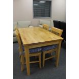 A pine kitchen table and four chairs