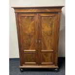 An antique continental walnut double door cabinet