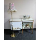 A 20th century Newhome electric sewing machine in cabinet and a standard lamp & shade