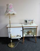 A 20th century Newhome electric sewing machine in cabinet and a standard lamp & shade